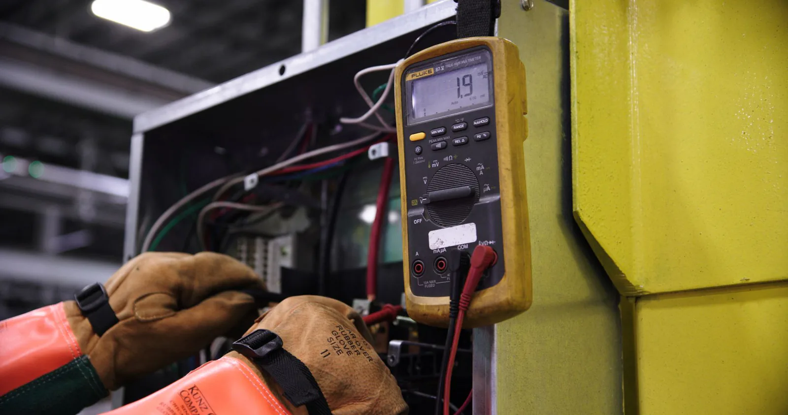 Electrician testing wiring in an electrical panel